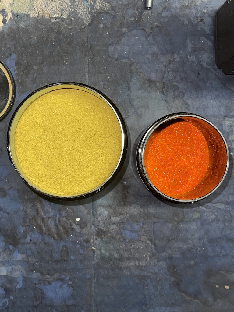 image of two powdery chemicals one is yellow one is red