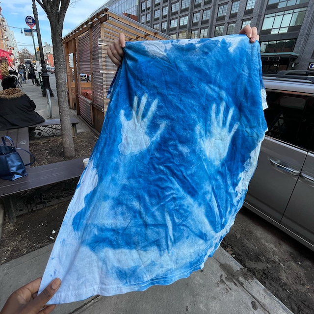 a cyanotype print of two hands on a shirt